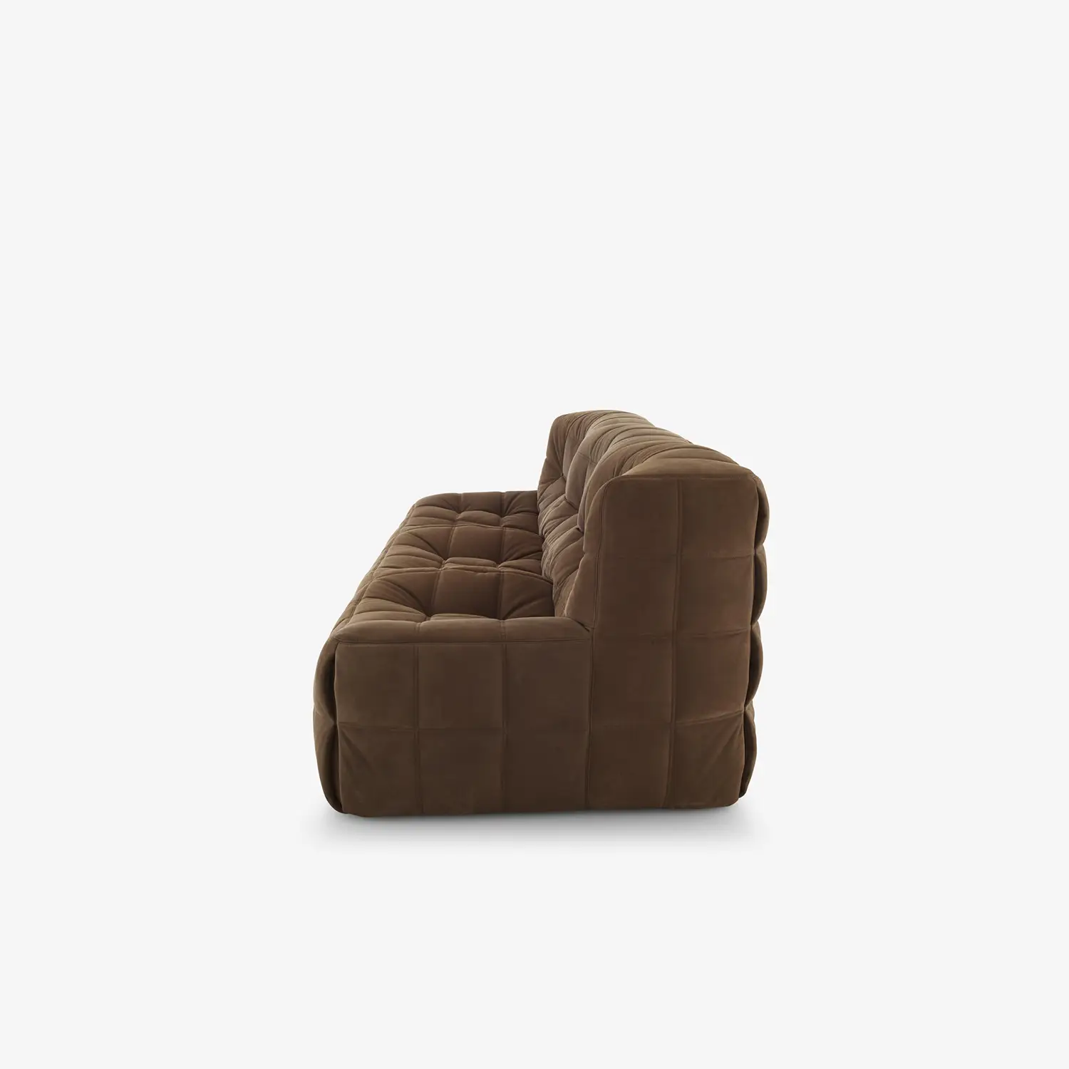 Side view of a modern brown tufted velvet sofa with deep cushioning and no visible legs on a white background.