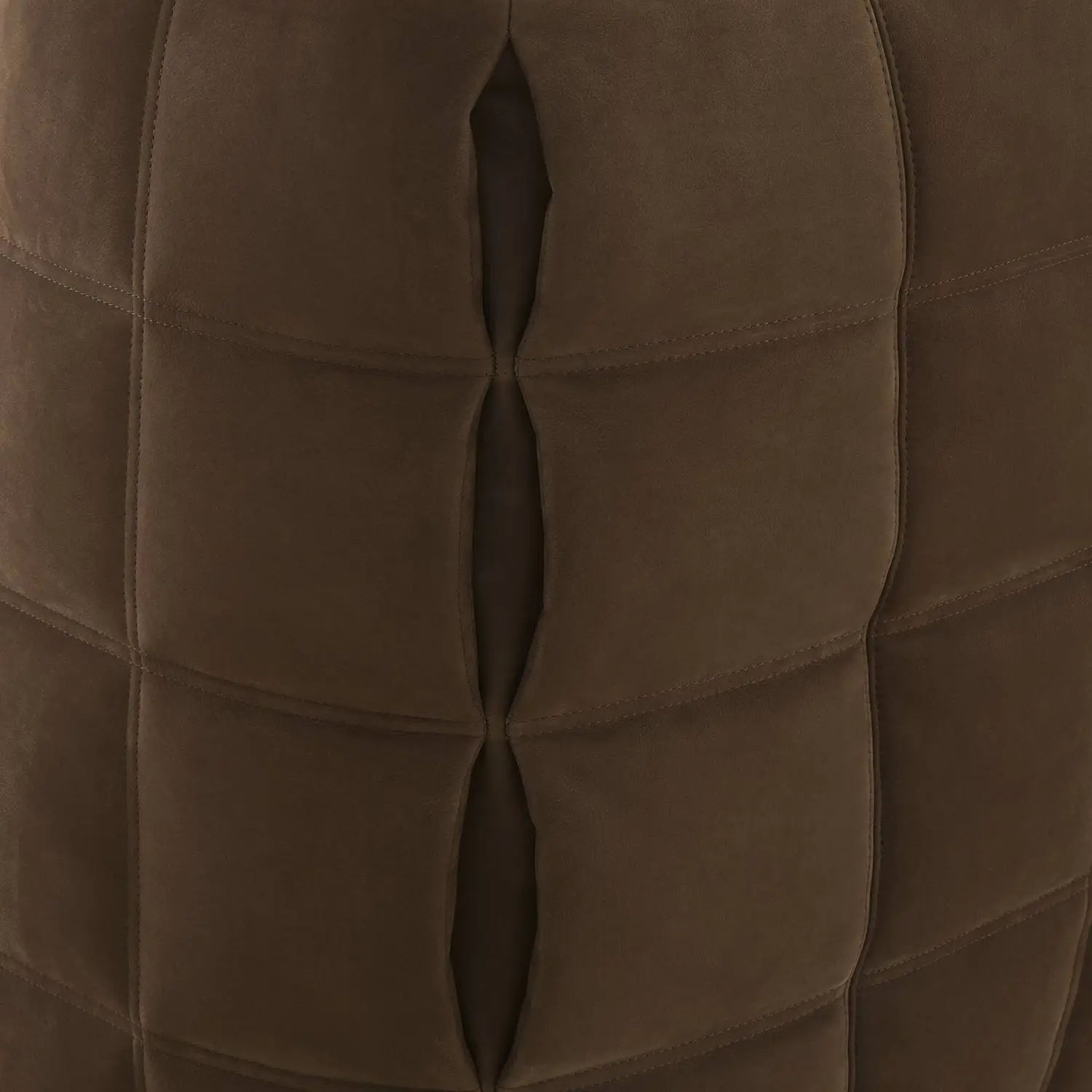 Close-up of brown suede upholstery with deep, vertical pleats and horizontal stitching.