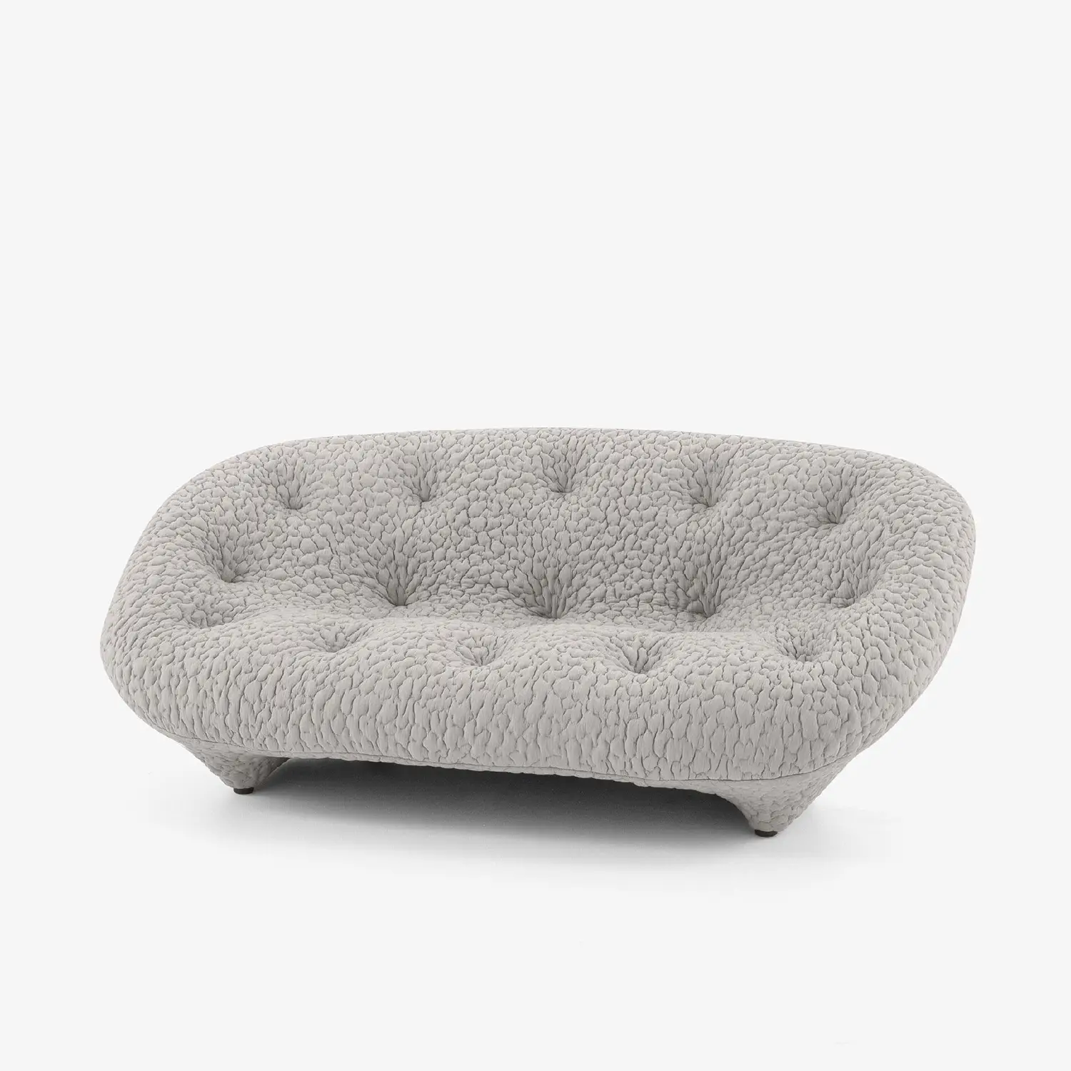 Gray tufted sofa with a rounded, cushioned design and textured fabric upholstery.