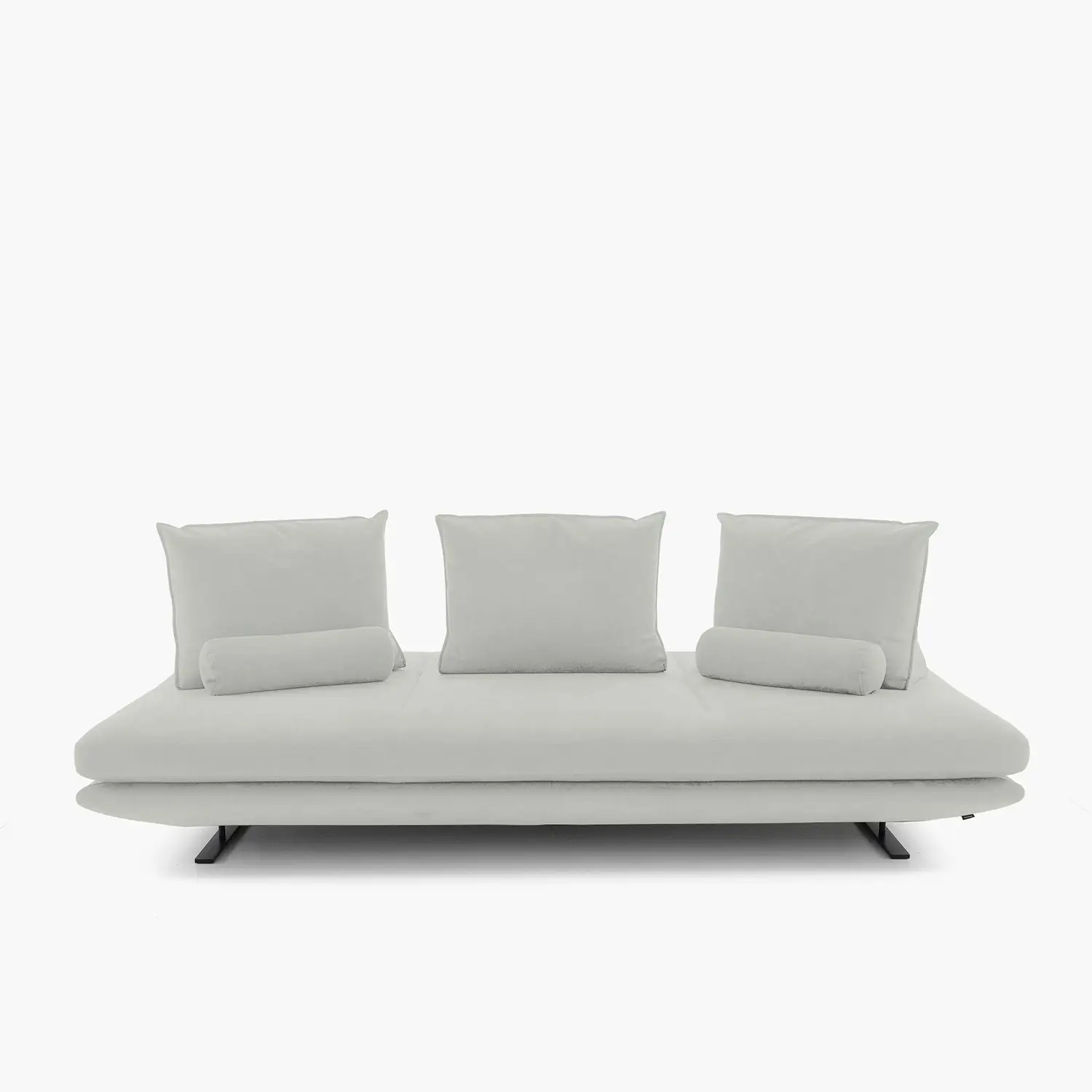 Modern light gray three-seater sofa with three square back cushions and two cylindrical bolster pillows on black metal legs.