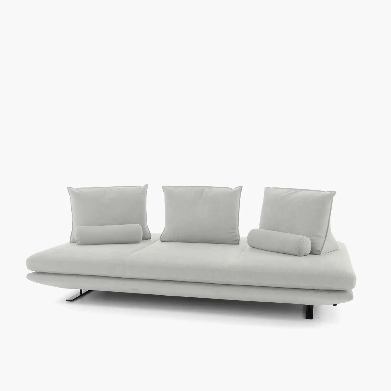 Modern light gray sofa with three back cushions and two cylindrical bolster pillows on minimalist black legs.