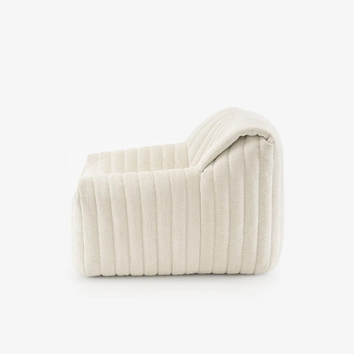 Side view of a modern, plush cream-colored armchair with vertically ribbed upholstery.