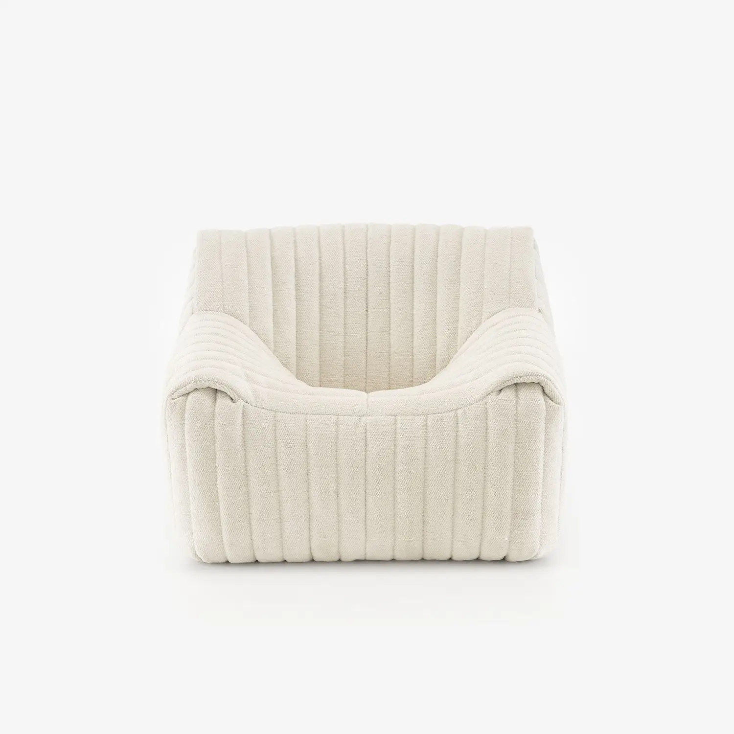 Modern low-profile armchair upholstered in cream-colored ribbed fabric.