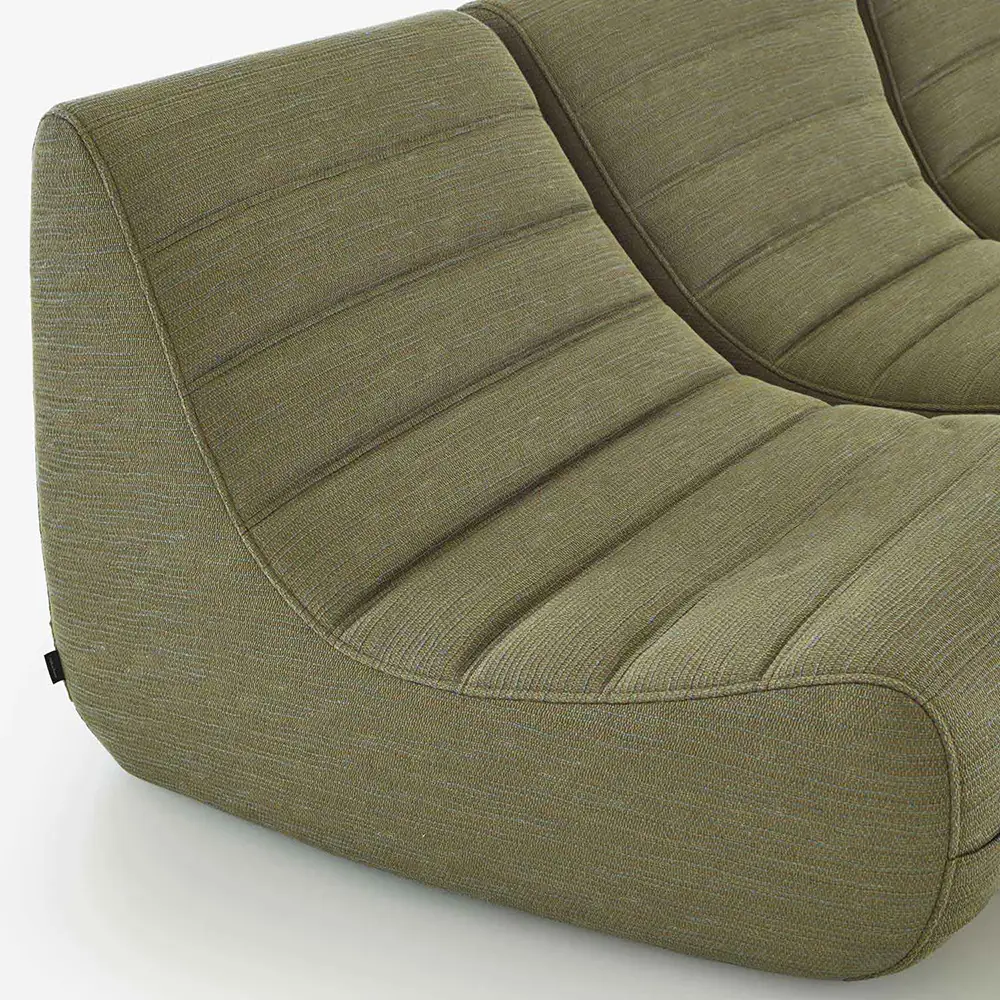 Close-up of a modern olive green fabric settee with rounded edges and horizontal stitching.